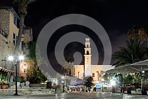 Kdumim square and St. Peter`s Church with the Clock Tower at night in old city Yafo, Israel.