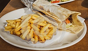 Kebab and French fries recipe white dish table in European country