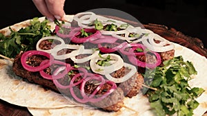 Kebab: grilled sausages on minced meat skewers with pita bread on a wooden board