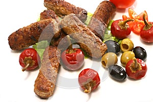 Kebab rolls olives and pepper over white
