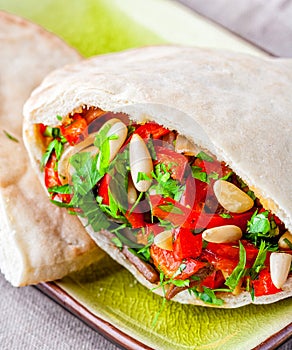 Kebab sandwich with vegetables and pine seeds