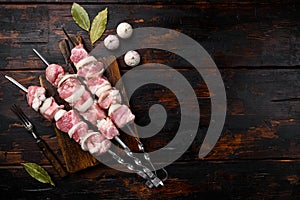 Kebab with spices and herbs, pork meat, top view flat lay, with copy space for text, on old dark  wooden table background