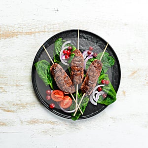 Kebab. Traditional middle eastern, arabic or mediterranean meat kebab with vegetables and herbs.