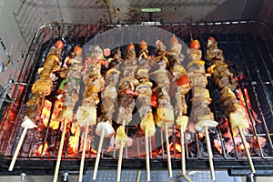 kebabs skewered with peppers and tomato sizzling