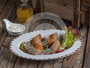 kebbah served in a dish isolated on wooden background side view of appetizer