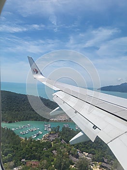 Kedah, Malaysia - 11 OCTOBER 2021 : View from window over Rebak Marina island in Malaysia Airlines flight to Langkawi island.