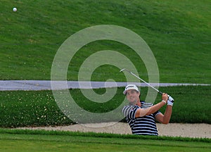 Keegan Bradley hits out of the bunker