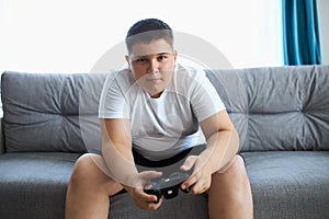 Keen caucasian boy playing video games photo