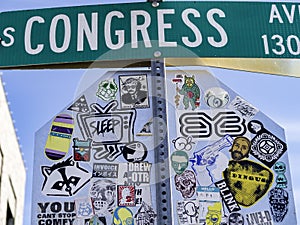 Keep Austin Weird: Congress Avenue street sign and decorated stop sign.