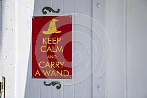 Keep calm and carry a wand gag humor sign hanging on wall