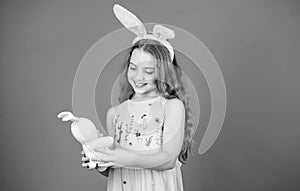 Keep calm and happy Easter. Little girl and rabbit toy. Small girl in rabbit ears with Easter toy. Little child in