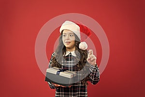 Keep calm. happy new year gift. time for christmas holiday presents. small girl in santa hat. cheerful child red