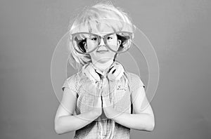 Keep calm and partying. Small child with DJ headphones. Little girl using wireless headset for DJ disco. Adorable DJ