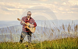 Keep calm and play guitar. Man hiker with guitar on top of mountain. Hiker enjoy nature. Musician hiker find inspiration