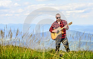 Keep calm and play guitar. Man hiker with guitar on top of mountain. Hiker enjoy nature. Musician hiker find inspiration