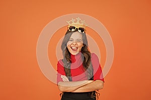 Keep celebrating. Happy girl enjoy celebrating orange background. Little child wear prop crowm and glasses. Celebrating