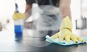 Keep it clean, keep it safe. an unrecognisable woman disinfecting a table at home.