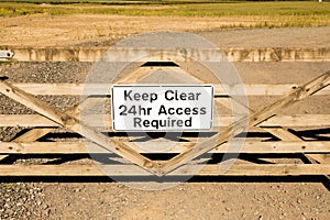 Keep Clear sign on wooden gate 24 hour access