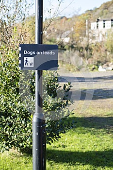 Keep Dogs On Leads Sign Post In Park Countryside