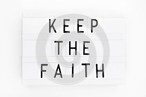 Keep the Faith, text written on a light box