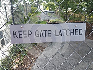 Keep gate latched sign on metal fence