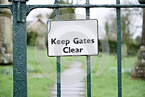 Keep gates clear sign on metal railing