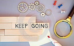 keep going - motivation or determination concept - handwriting on a sticky note.