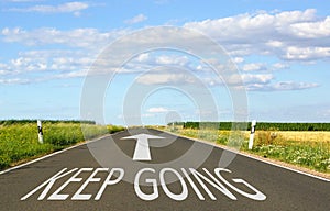 Keep Going - street with arrow and text