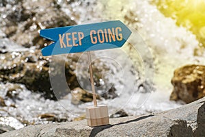 Keep going sign board on rock