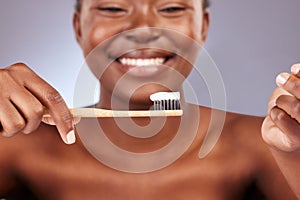 Keep a healthy smile. Studio shot of a beautiful young woman brushing her teeth.