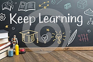 Keep learning written on chalkboard. Concept of knowledge, improvement, development and keeping up the motivation to learn new