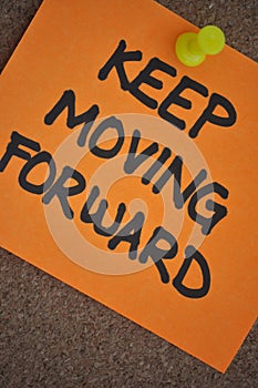 Keep Moving Forward Note on Pinboard photo