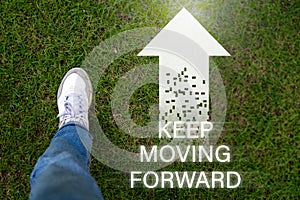 Keep moving forward symbol. Concept words keep moving forward on blocks against a beautiful grass background