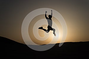 Keep moving. Silhouette man motion jump in front of sunset sky background. Daily motivation. Healthy lifestyle personal