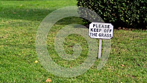Keep off the grass sign on the lawn of a country estate