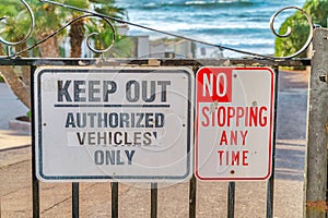 Keep Out Authorized Vehicle Only and No Stopping Any Time sign on iron gate