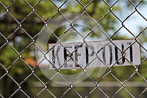 Keep out sign on fence