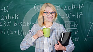 Keep positive attitude to work. Woman with tea cup and document folder chalkboard background. Time to relax. Teacher