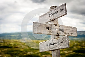 keep pushing forward signpost outdoors