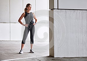 Keep pushing, keep persisting. a sporty young woman taking a break while exercising outdoors.