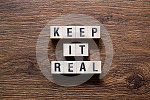 Keep it real - word concept on building blocks, text