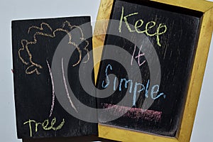 Keep it Simpe on phrase colorful handwritten on blackboard,