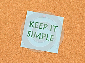 KEEP IT SIMPLE reminder note over a kork board.Text sign showing Keep It Simple. Conceptual photo ask something easy understand