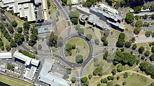 Keep it slow but keep it moving. 4k drone footage of vehicles driving around a traffic circle in Cape Town, South Africa