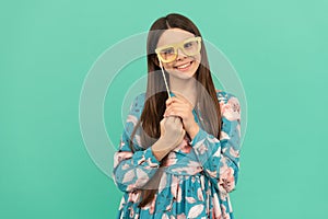 Keep smiling. Happy child smile holding prop glasses. Happy childhood and girlhood photo