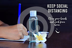 Keep social distancing. Clean your hands and work from home concept. With young woman hand holding blue pen writing on book.