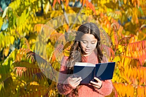 Keep studying. Small girl read book on autumn day. Small child enjoy reading autumn foliage background. Little child