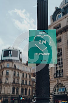 Keep two metres distance sign on a street in London, UK