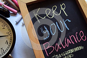 Keep your balance on phrase colorful handwritten on chalkboard