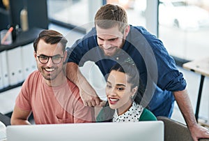 Keep your eyes on trends then capitalise on them. a group of young businesspeople using a computer together in a modern